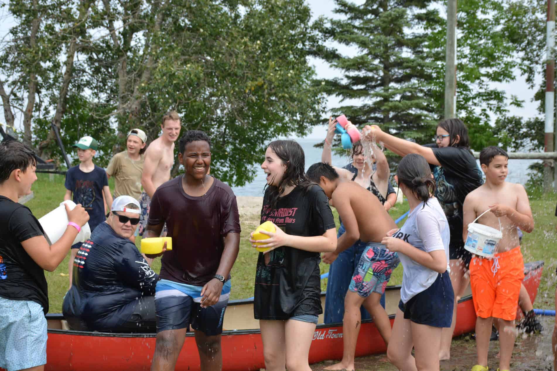 manitoba summer camp kids having water fights